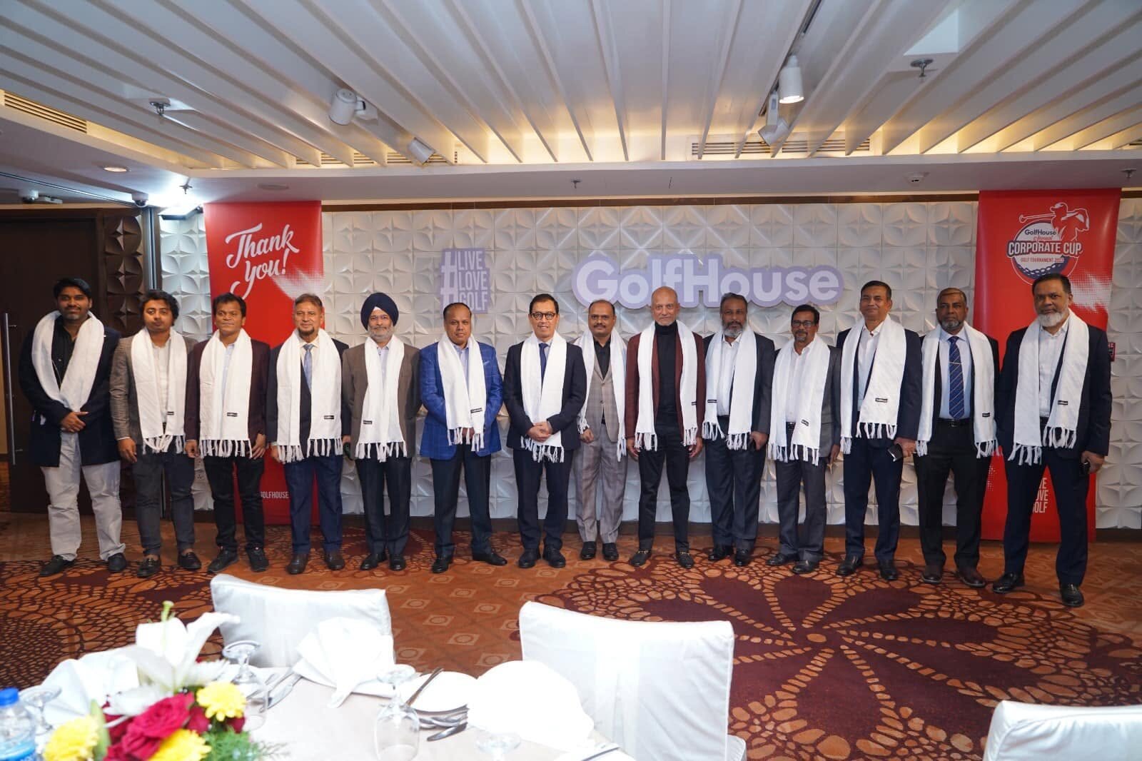 Guests and participants on stage at a GolfHouse event