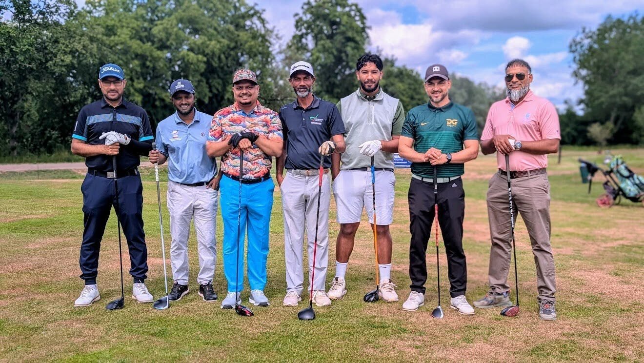 Nazrul Hosen with golfers on a golf course